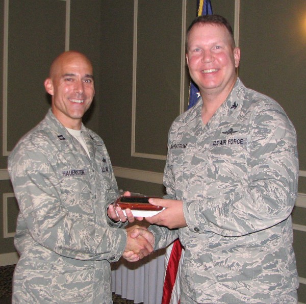 Capt. Keith Hauenstein, USAF (l), TechNet chairperson, shakes hands with Col. Bjurstrom at the June meeting. Capt. Hauenstein received the chapter’s Meritorious Service Award for putting together its Heartland TechNet for 2013.